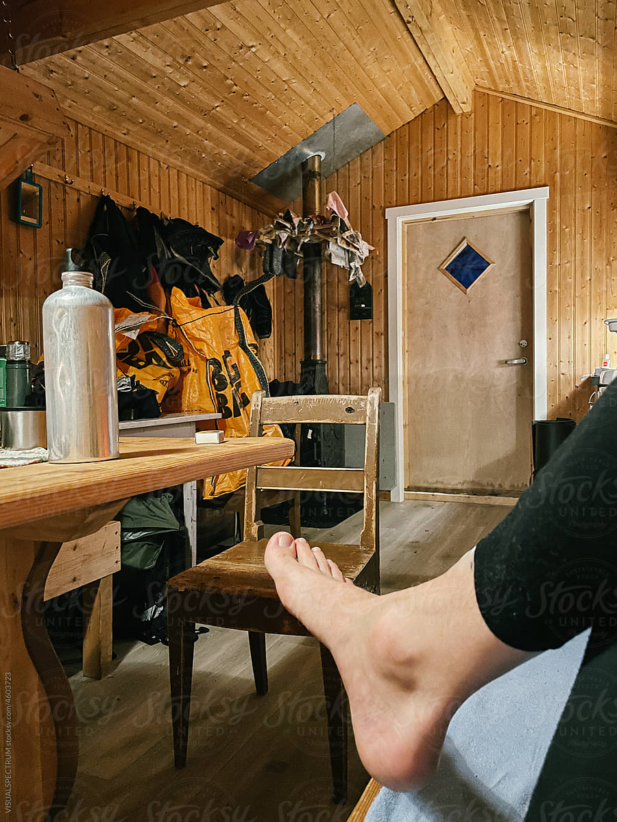 Anonymous Skier Resting in Wooden Cabin