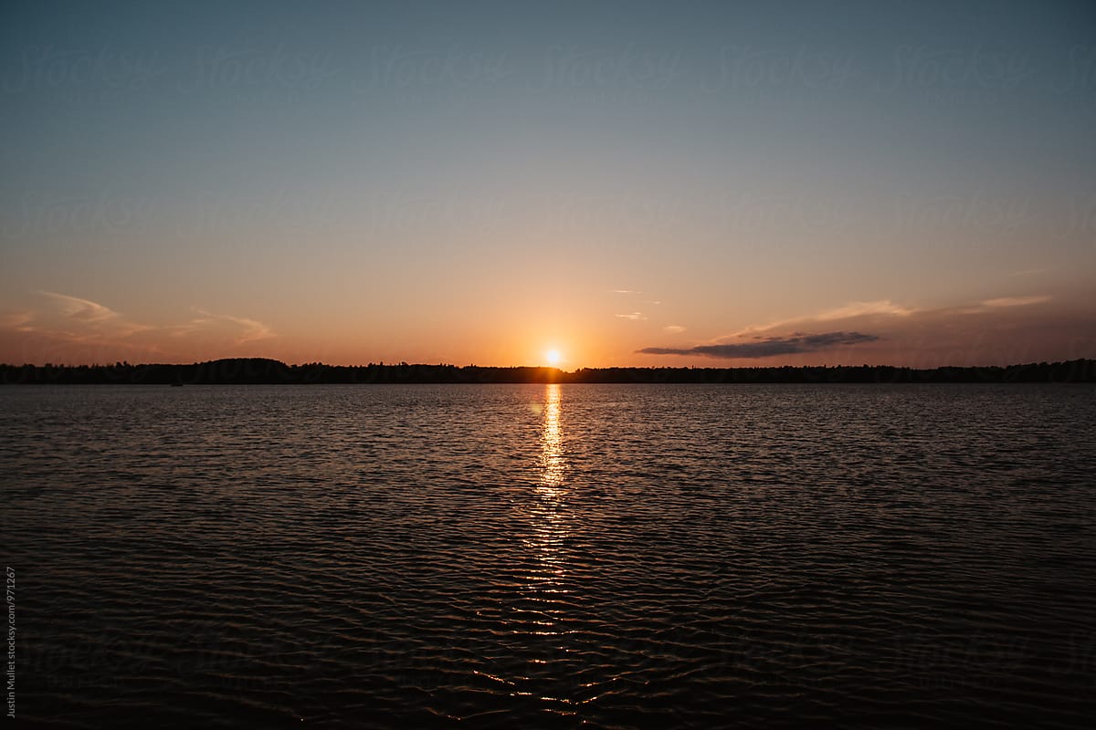 Thin horizon on lake during sunset