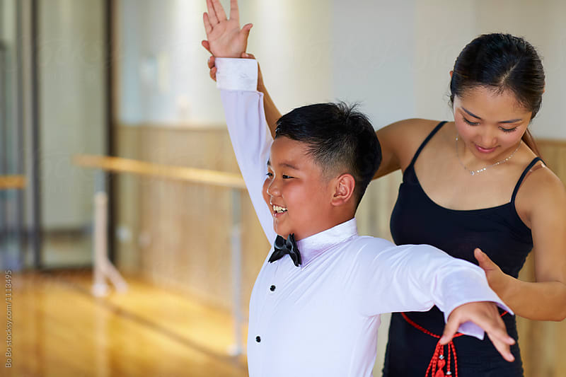 young asian dancing teacher teach her student dance indoor