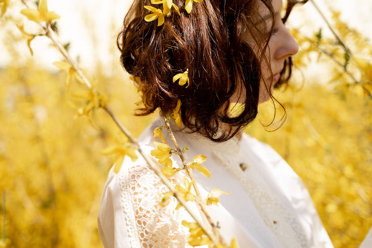Woman Surrounded By Blooming Forsythia