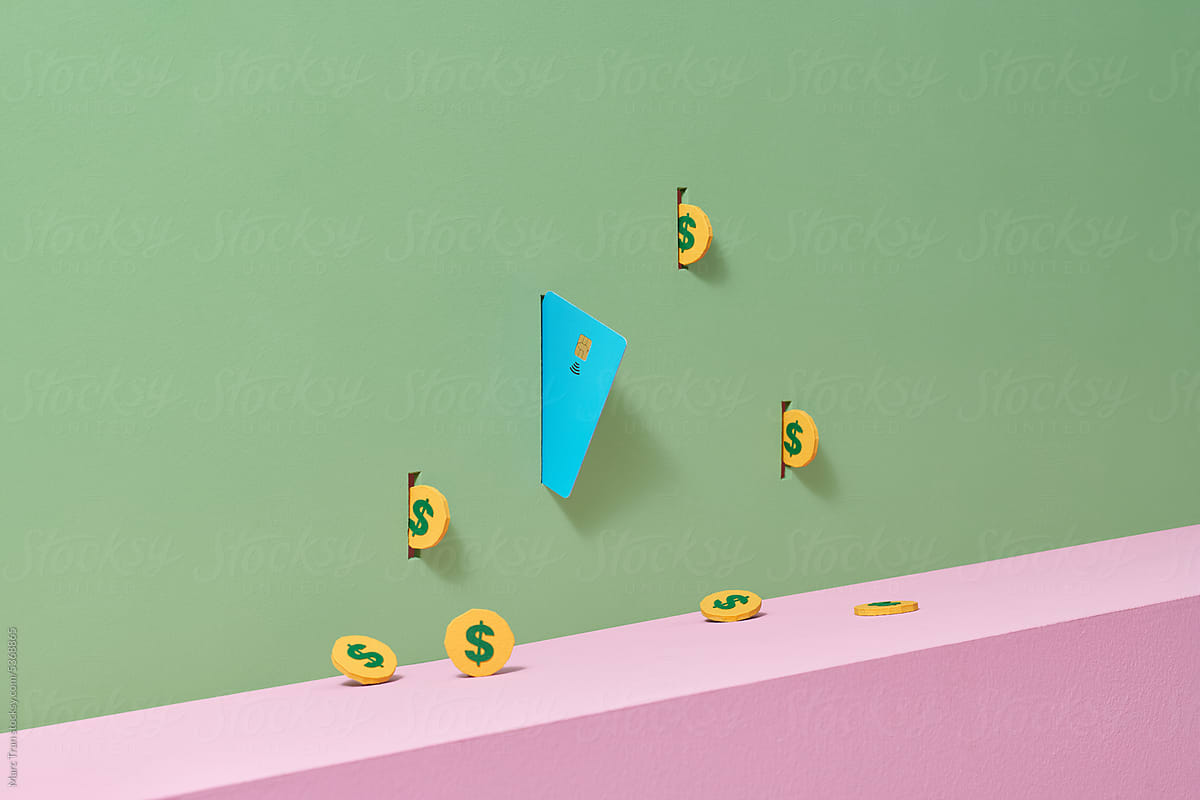 Coins with Credit or debit card floating on green background
