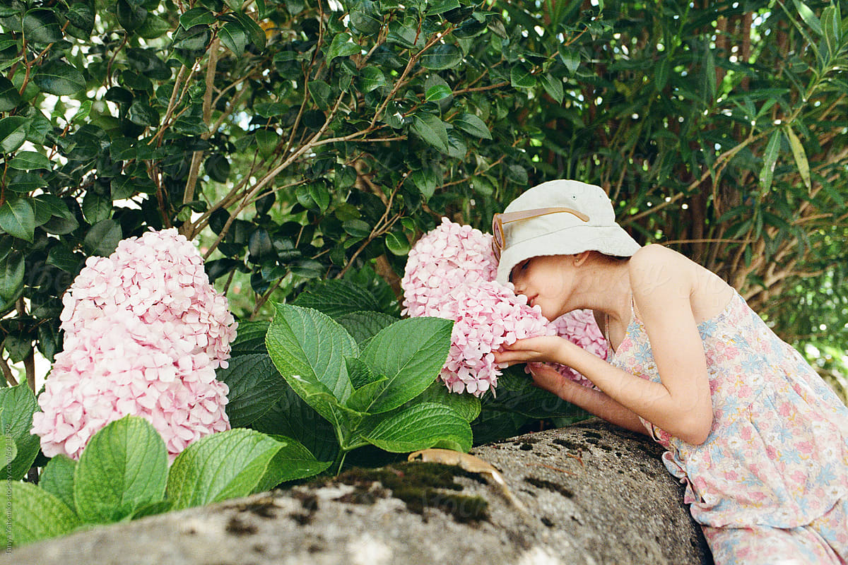 A girl smelling the flowers outdoors