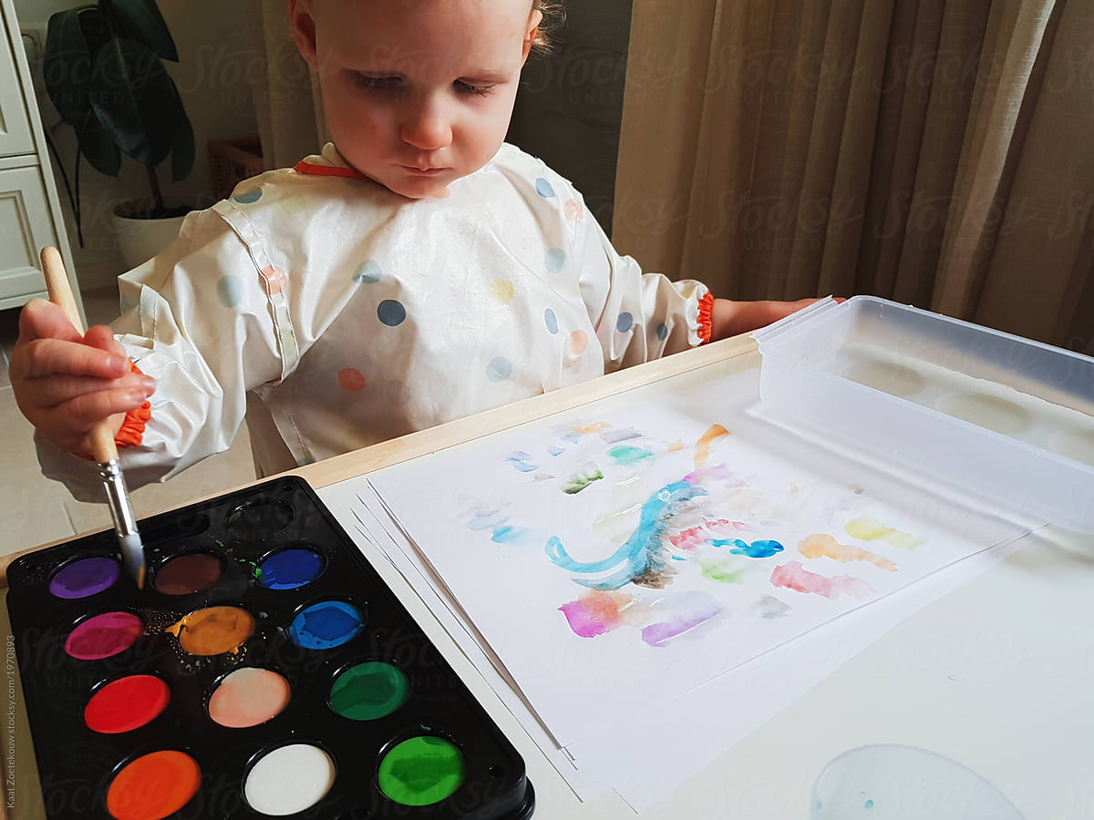 Toddler watercolors for the first time, with her mom's help.