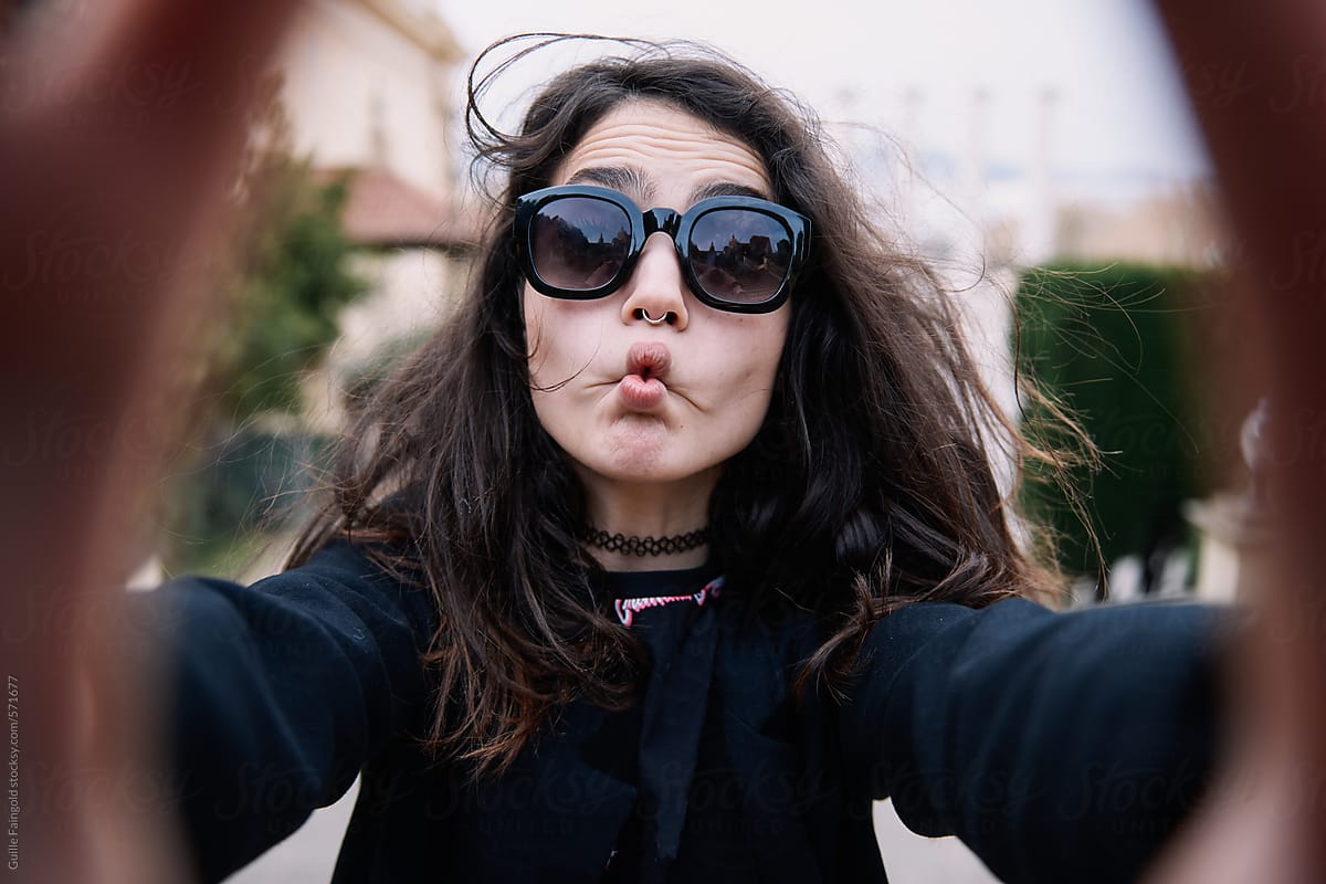 Grimacing Woman Taking Selfie By Stocksy Contributor Guille Faingold Stocksy 