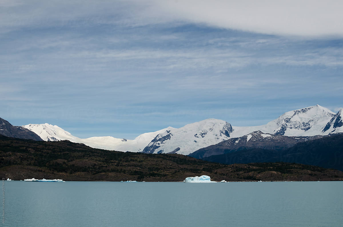 Lake with icebergs and mountain chain