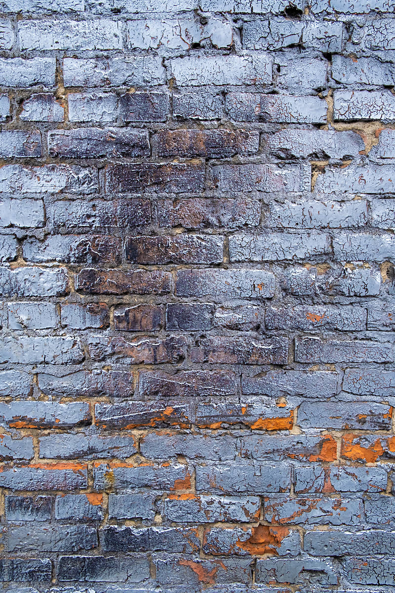 Stock image of old brick wall covered in metallic spray paint