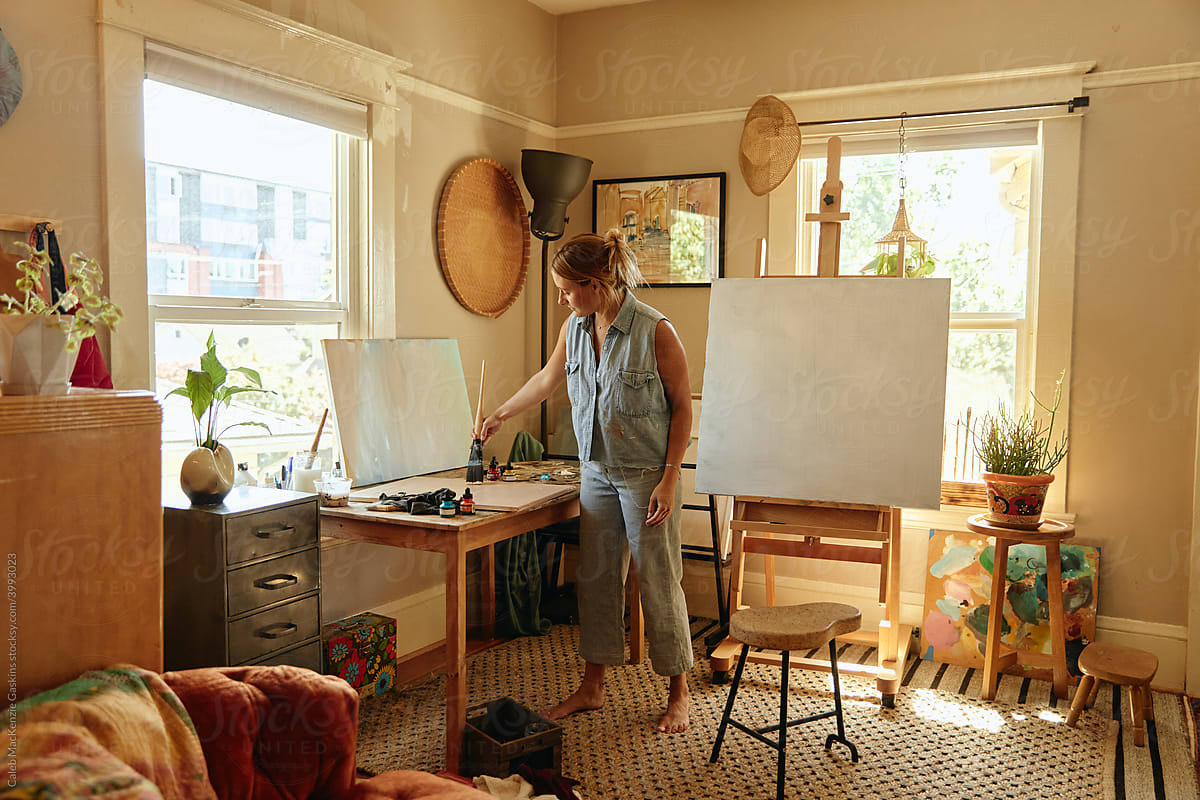 Woman painting in a home studio.