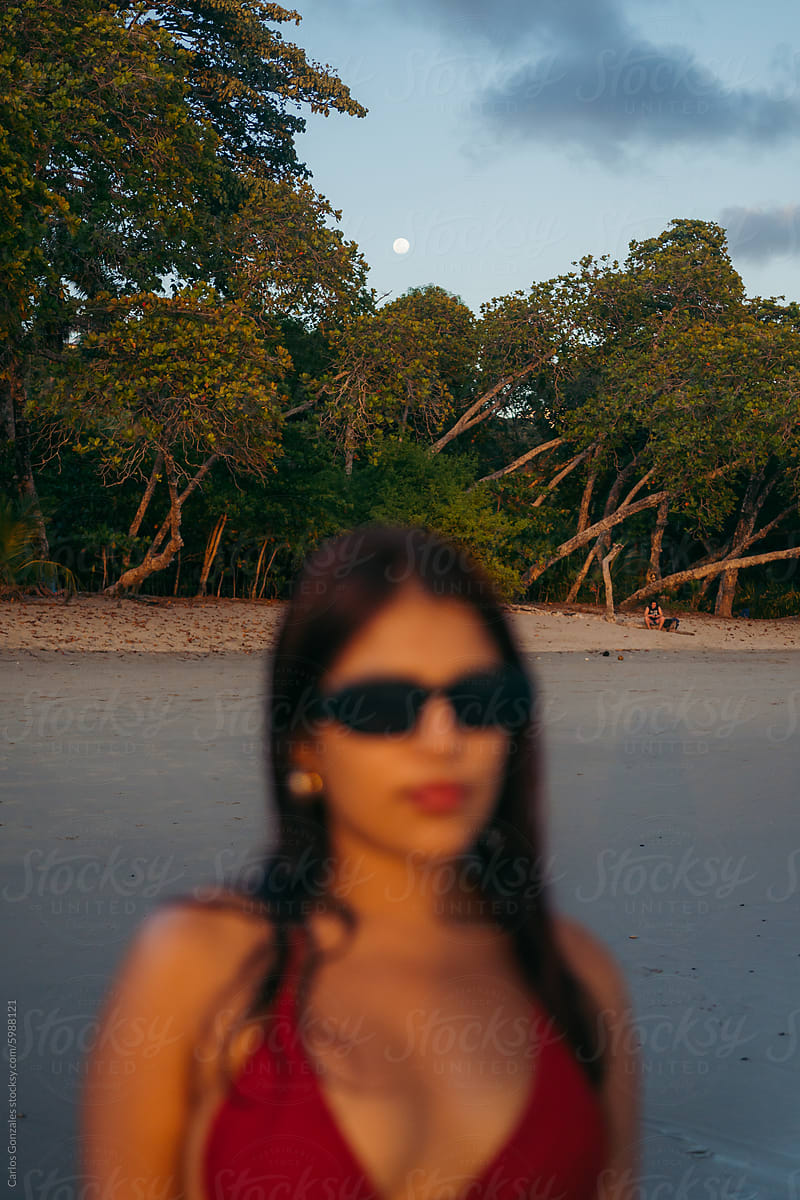 Portrait of young woman in the beach during twilight