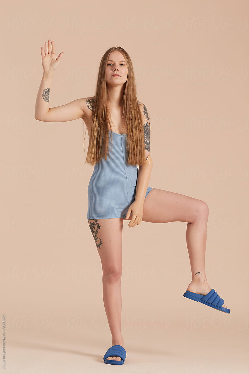 Active Girl Raising Hand And Leg