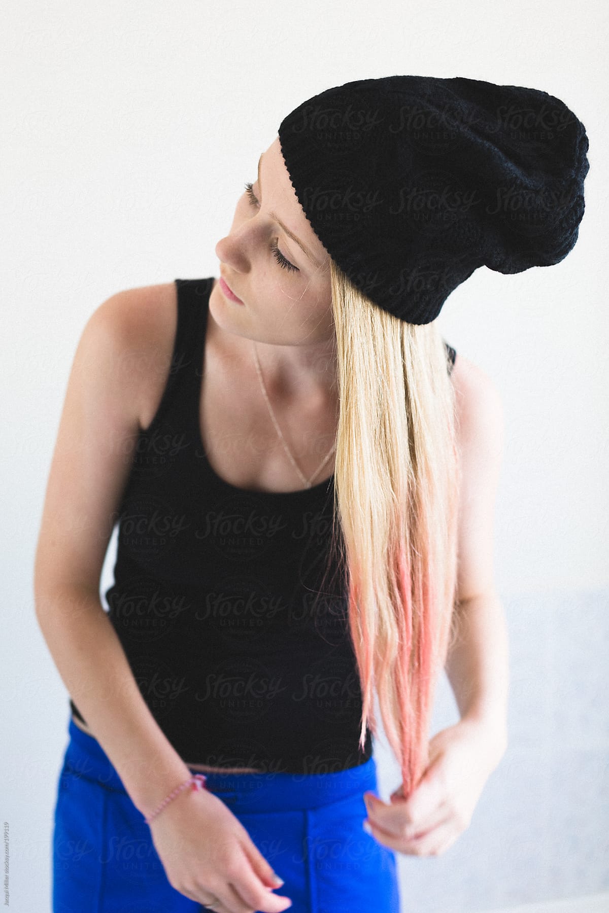 Teenage Girl Putting Pink Hair Day On The Tips Of Her Long Blonde