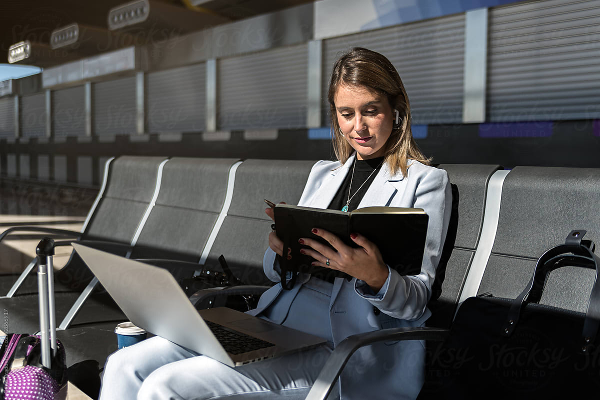 business woman working with laptop at the airport waiting her flight