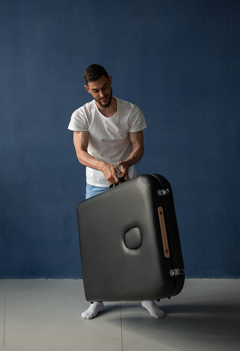 Male masseur with portable table