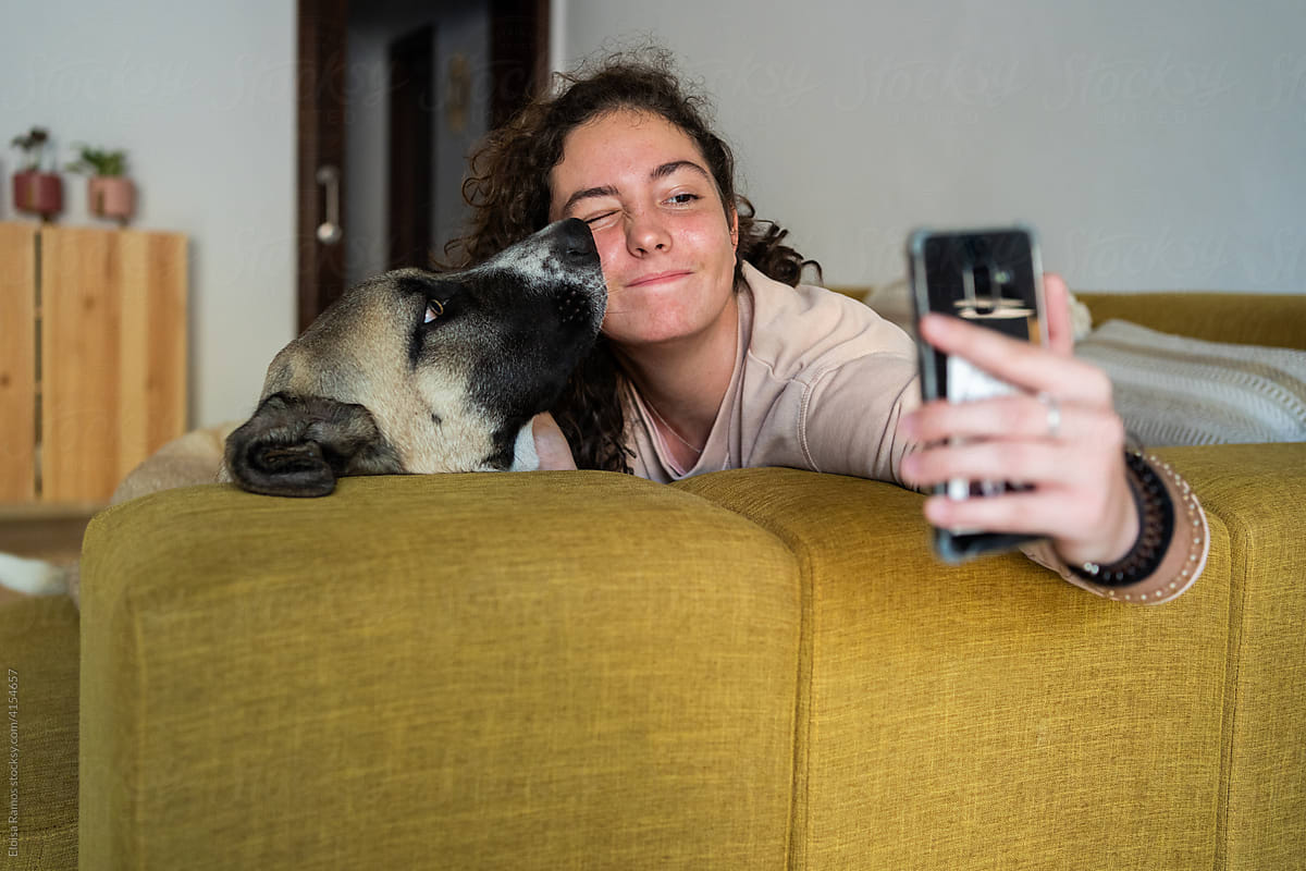 Teenager and dog taking selfie