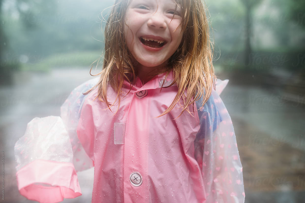 Close up of little Girl playing in the rain