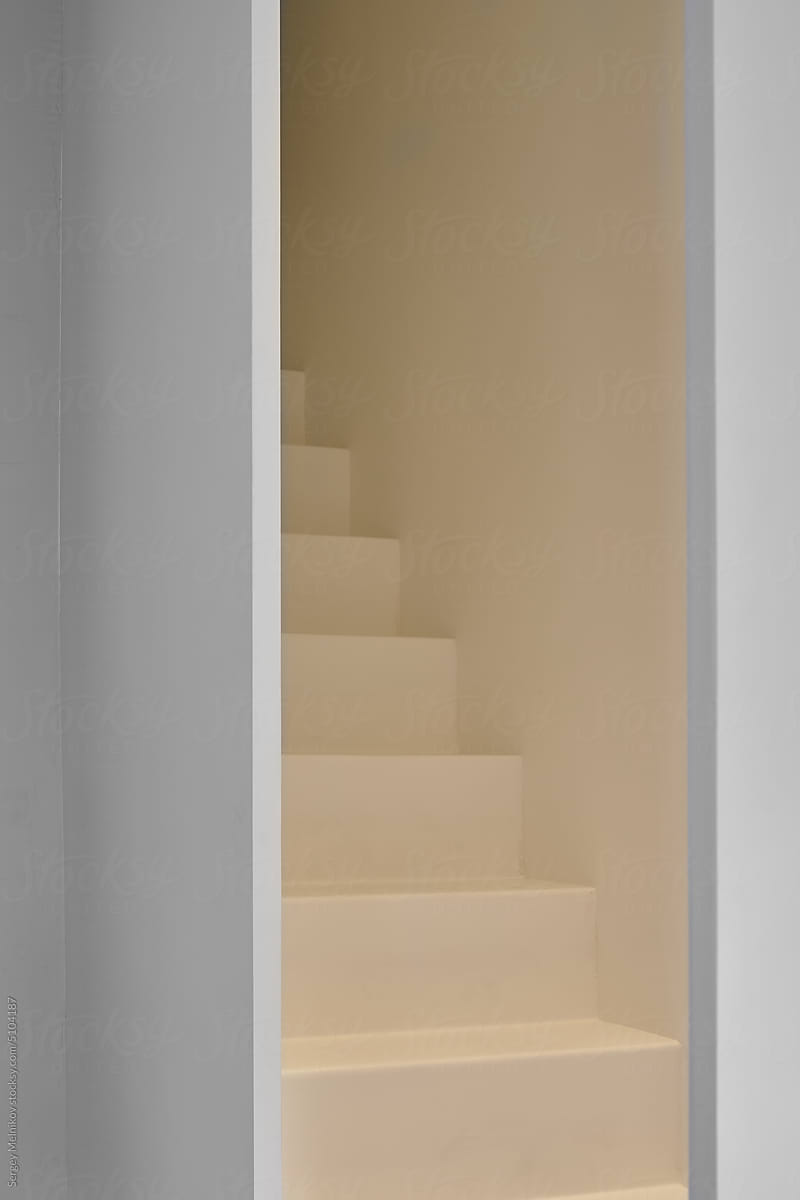 Modern staircase behind opened door