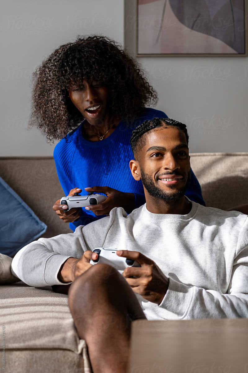 Gaming On Couch by Stocksy Contributor Atolas - Stocksy