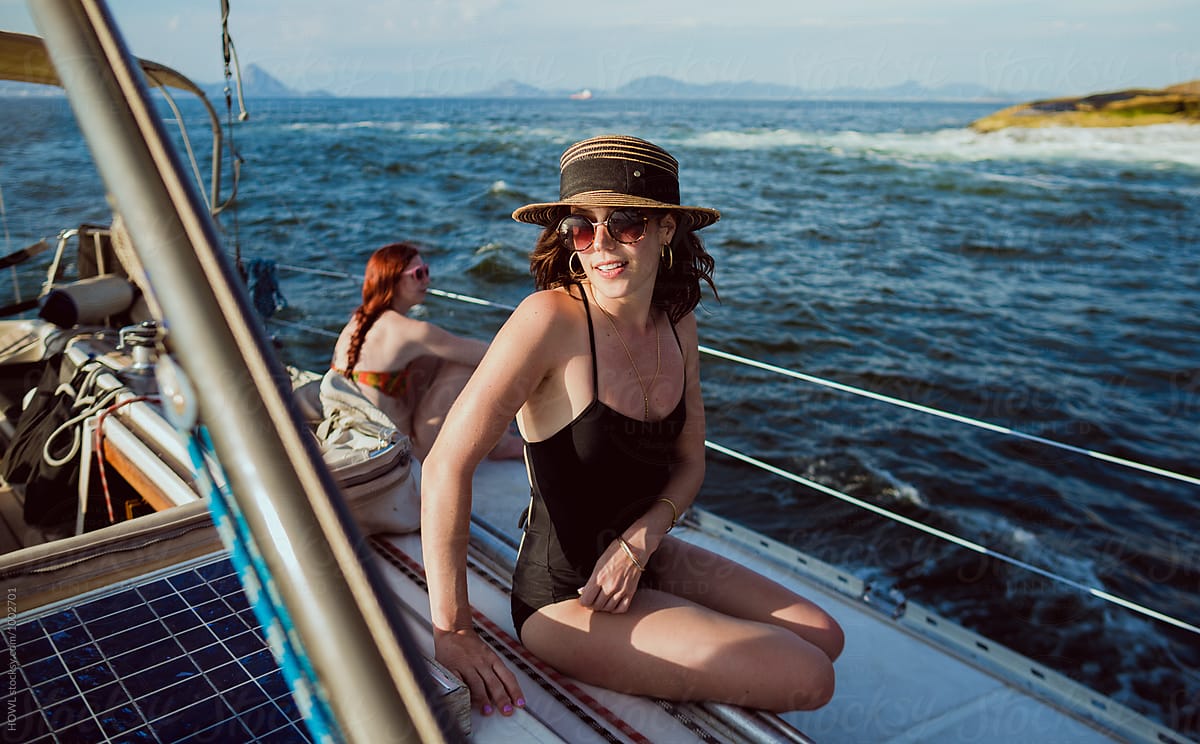 Young woman relaxes in the sun on a summer cruise
