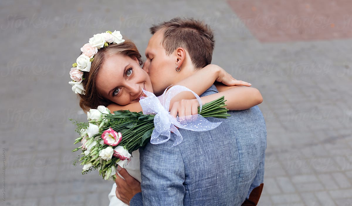 Young stylish couple in love posing on the street. Wedding  photo