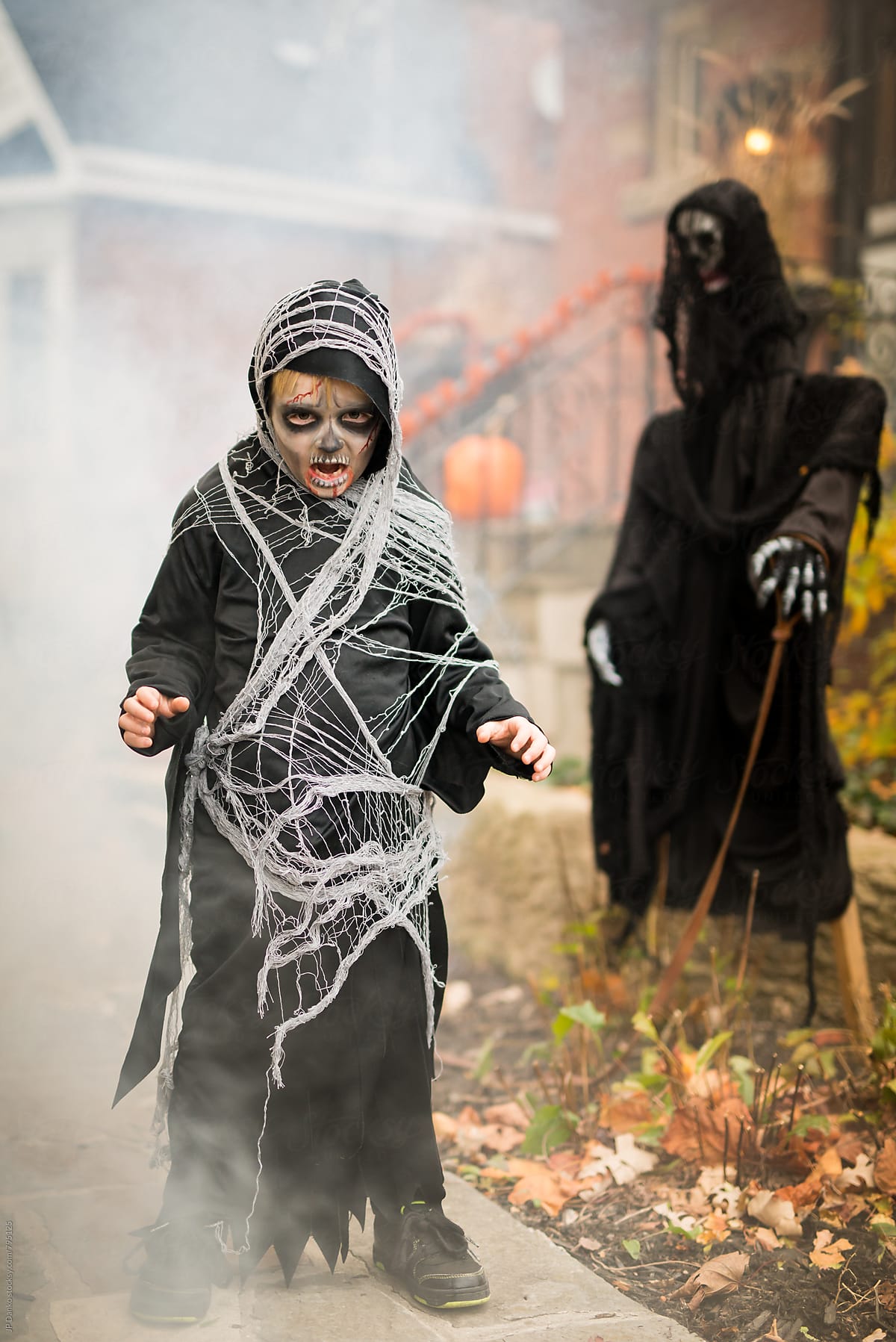 Scary Boy Dressed Up As Grim Reaper Halloween Costume Outdoors at House