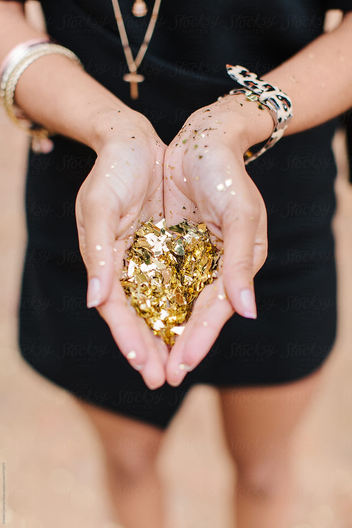 Gold confetti woman hands