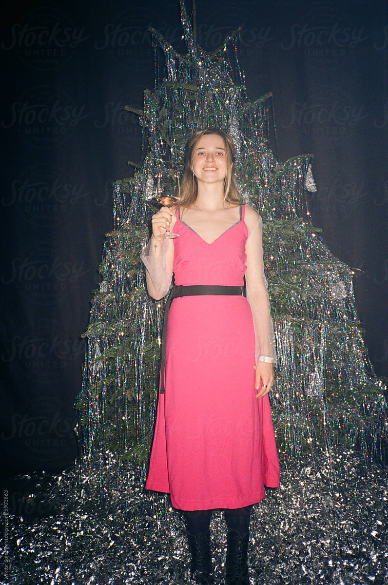 Cheerful woman with Christmas tinsel on black background