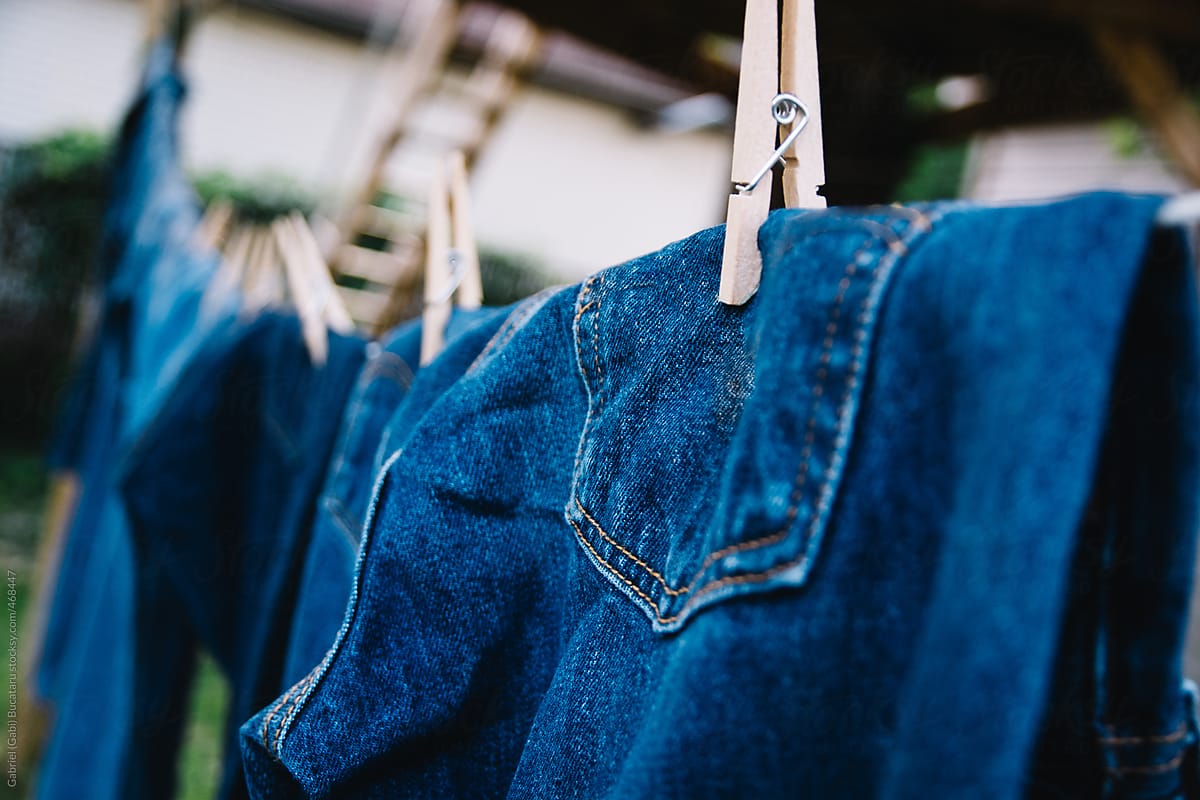 Blue jeans hanging oudoors on a clotheline