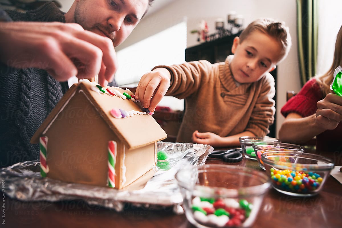 Christmas: Father And Son Working On Gingerbread House