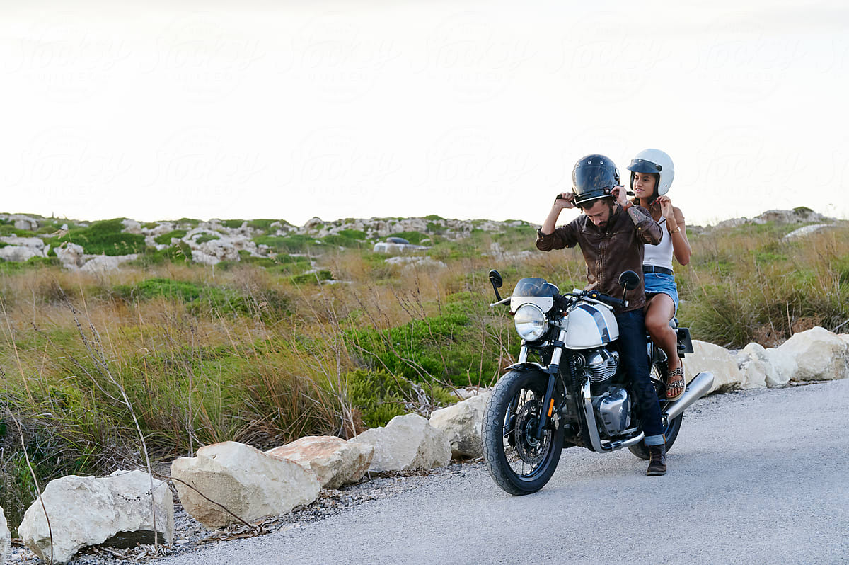 Couple taking a break from a motorbike ride