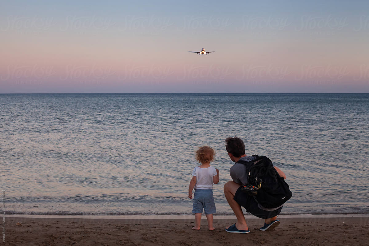 travel, father and child looking at airplane
