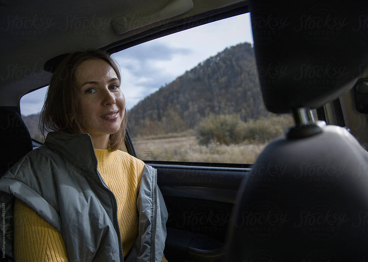 Traveling woman in car in mountains