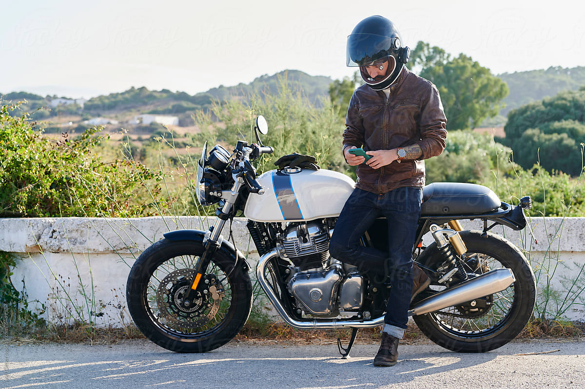 Motorbike rider checking his cellphone gps