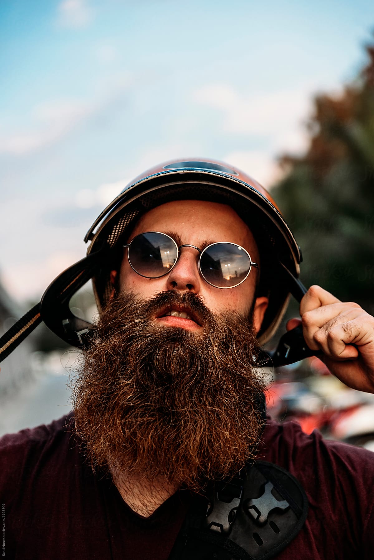 Portrait Of Hipster Bearded Biker In The Street. Casual Attitude by Santi Nuñez