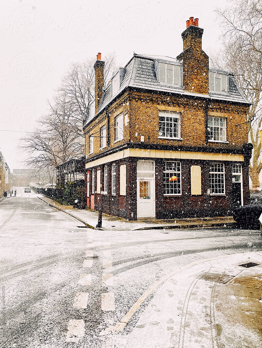London pub building in winter on a snowy day.