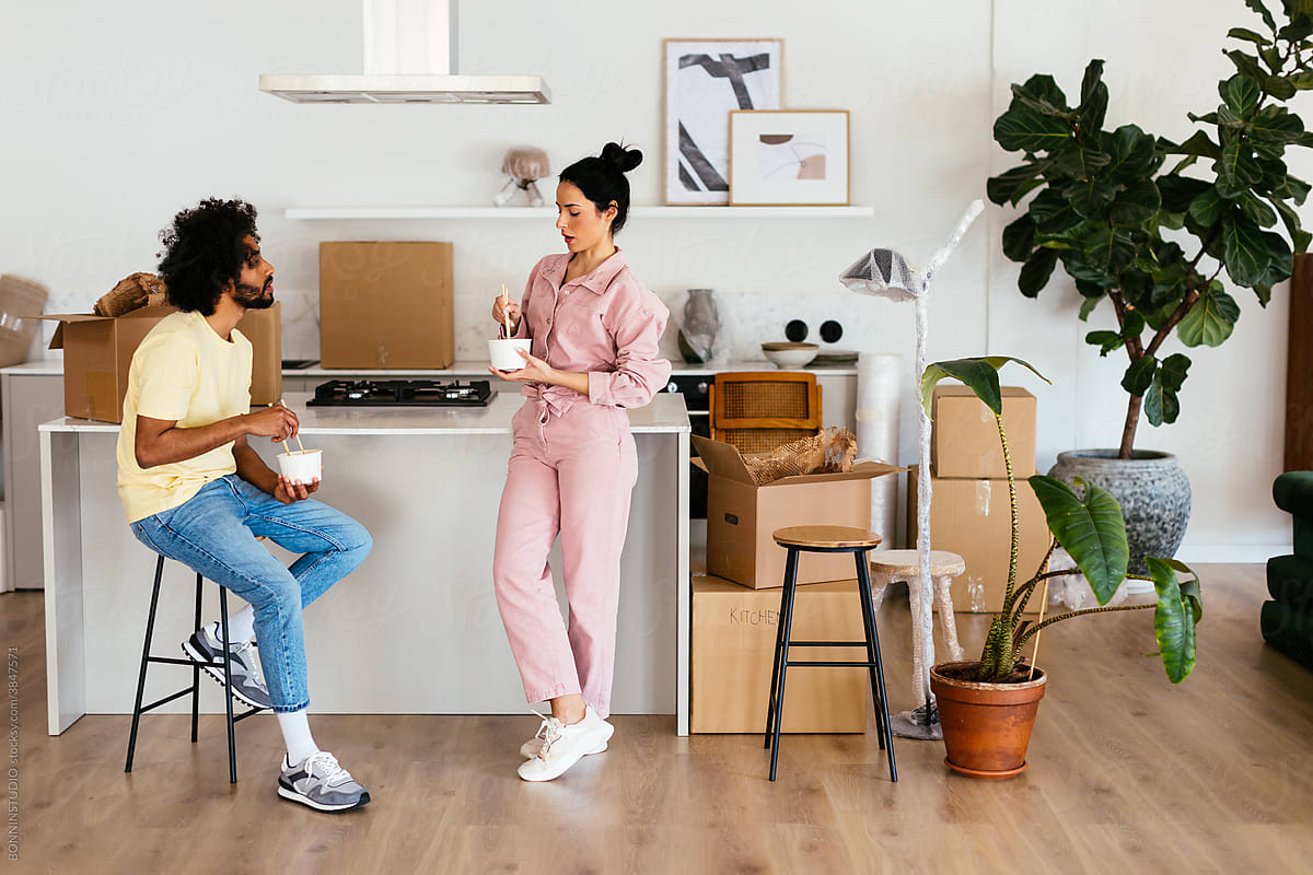 Couple having lunch in kitchen during relocation