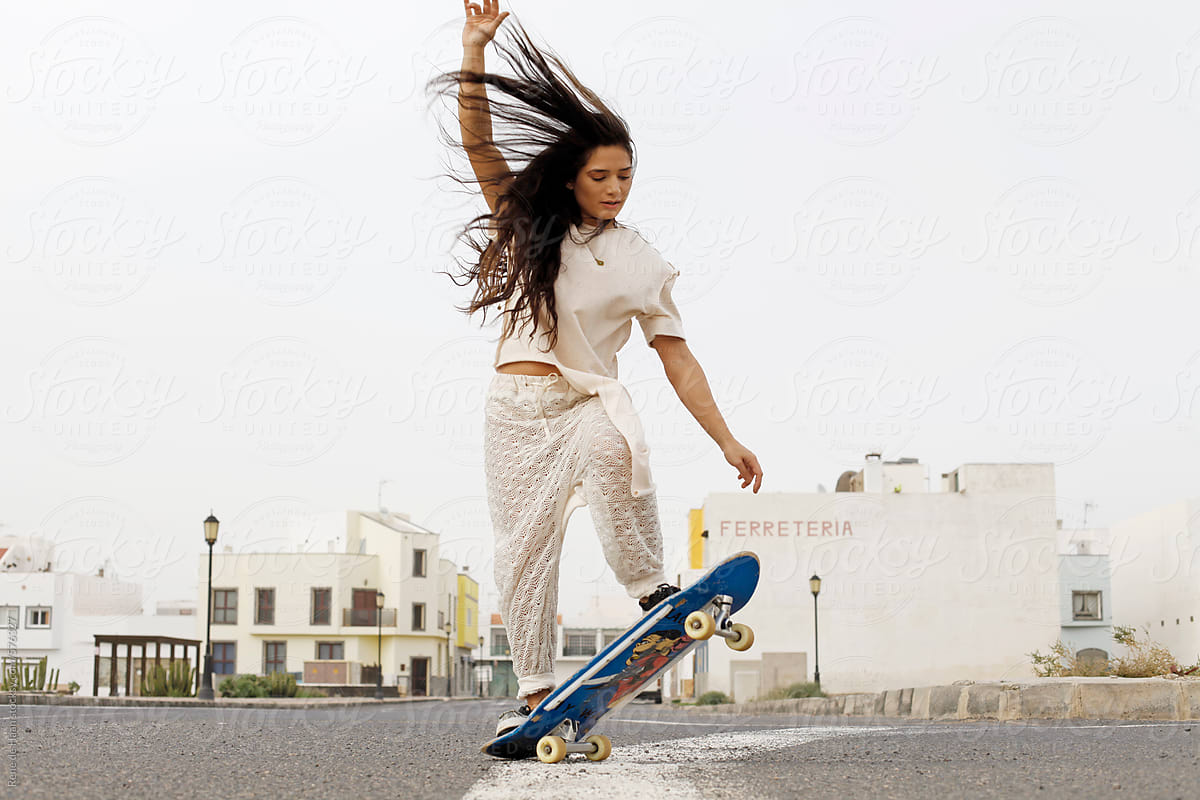 young woman on skateboard in town