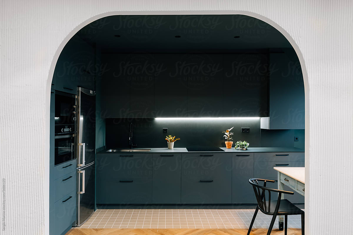 Interior of modern kitchen behind arch