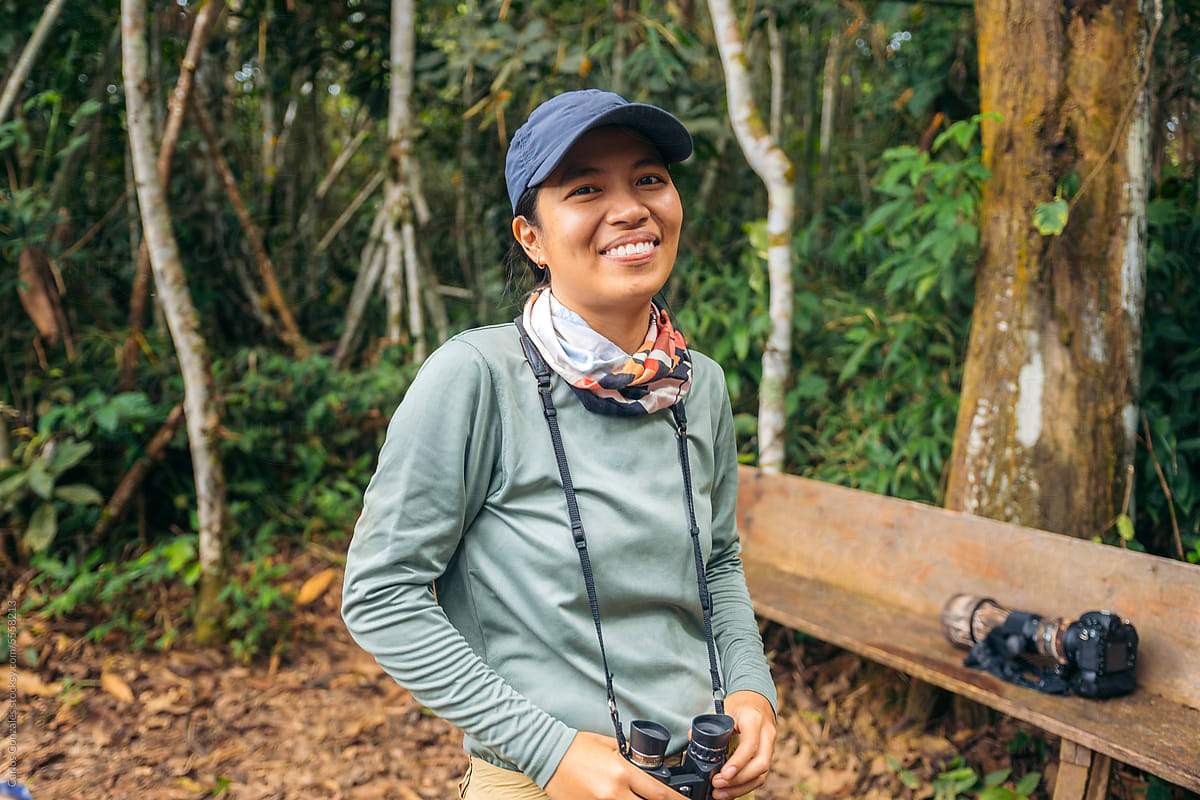 Woman with binoculars in the jungle