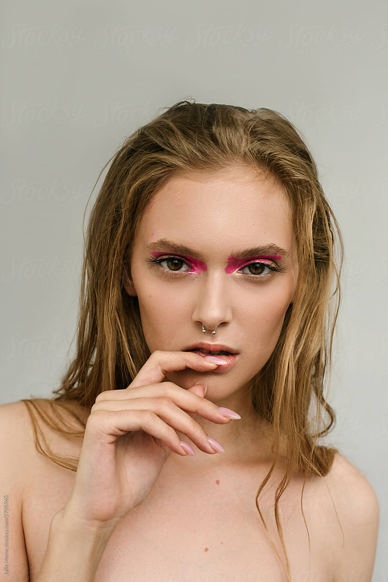 Beauty portrait of a girl with pink make up and  nose piercing