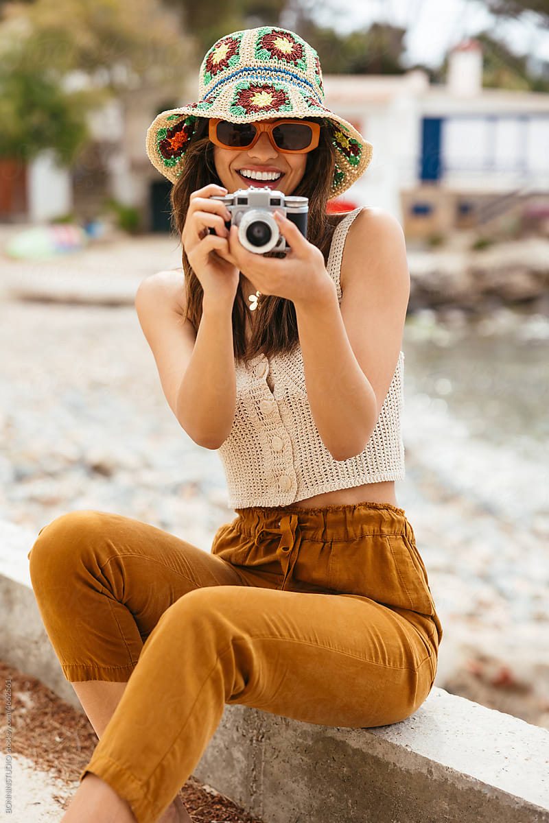 Female tourist taking photo on beach