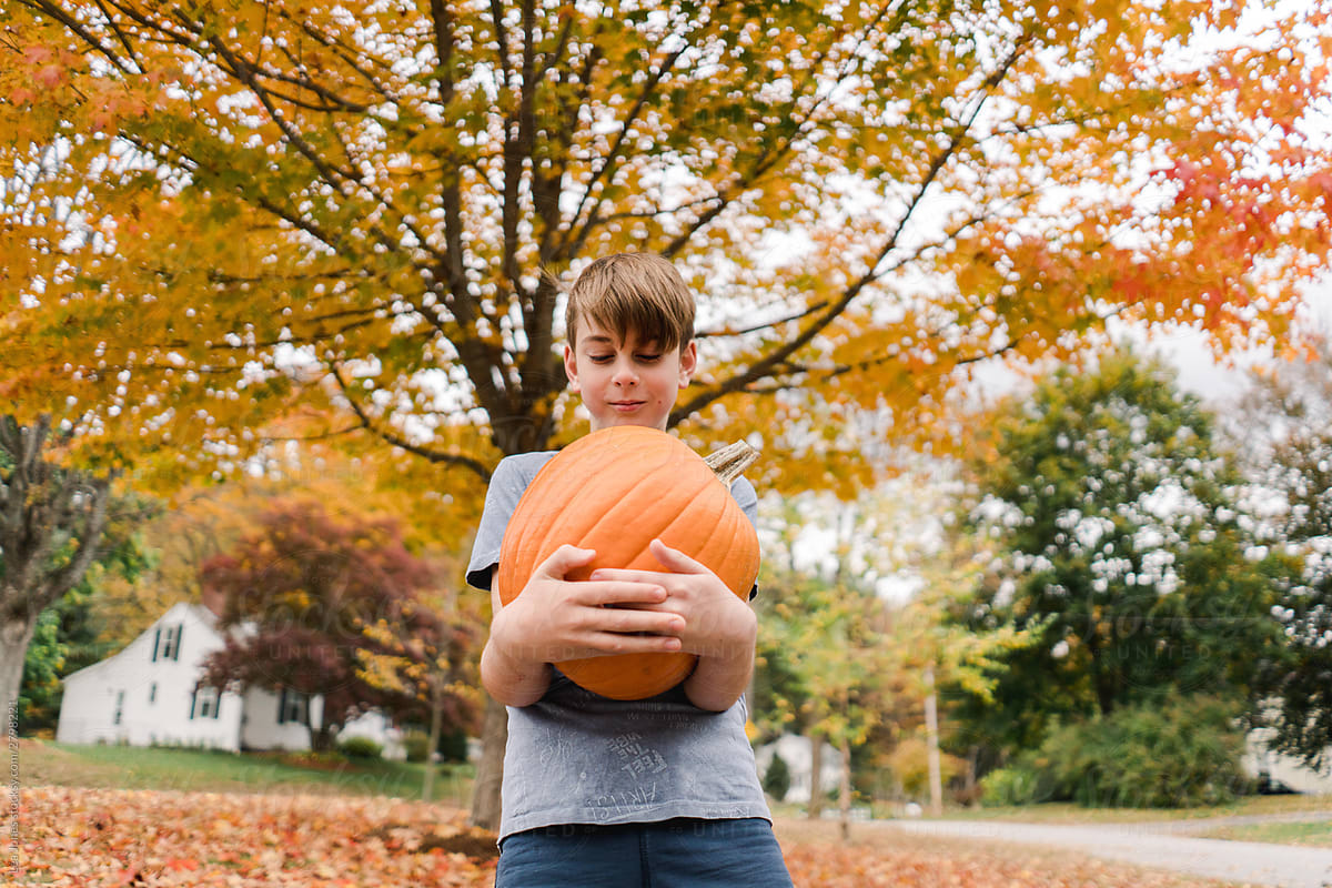 boy holding pumpkin