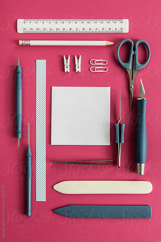 Papercraft tools on pink background