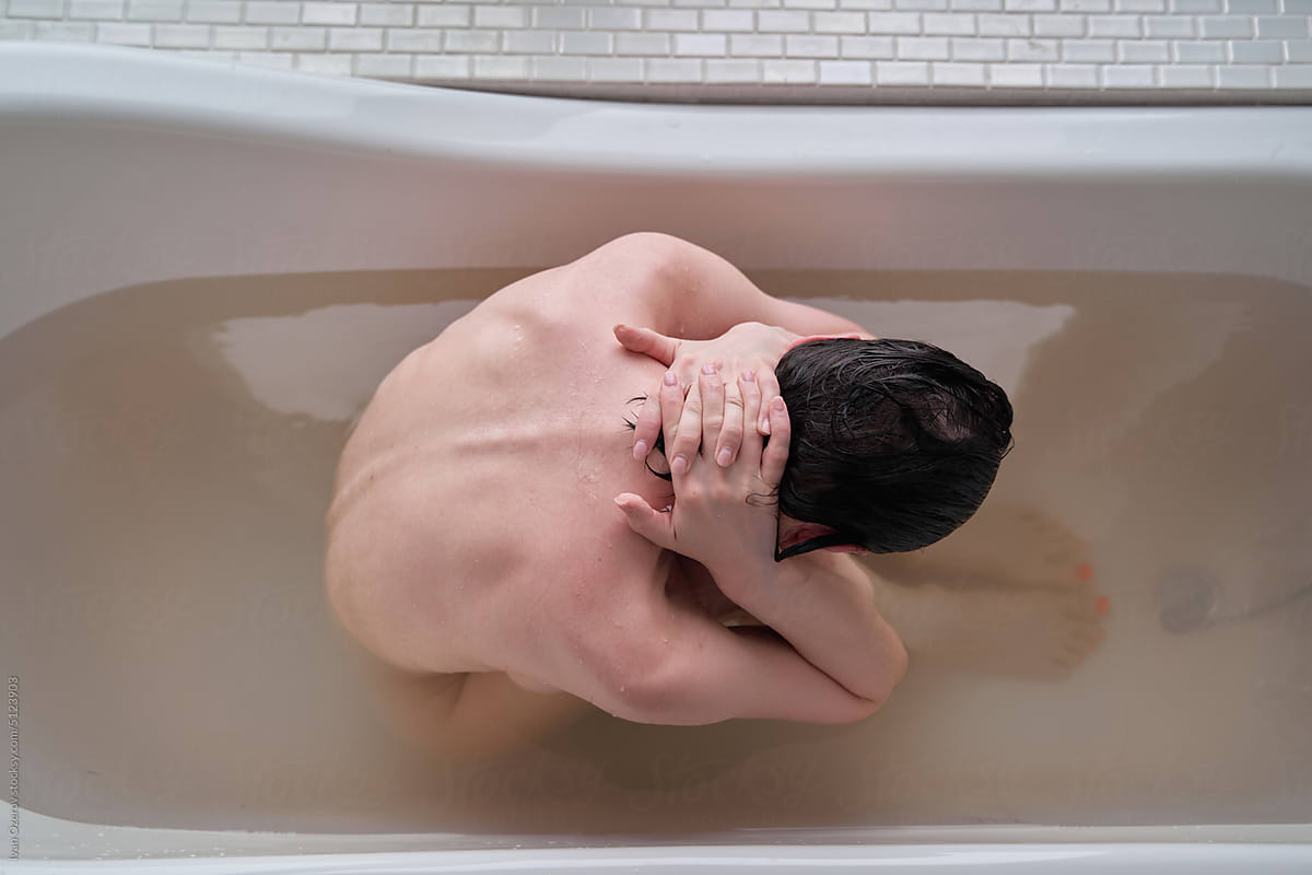 Depressed woman taking bath at home
