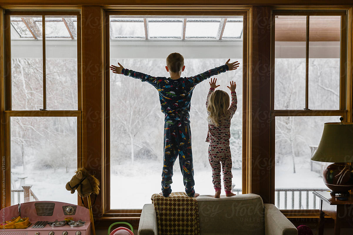 Brother And Sister Looking Out Window After Snowstorm By Raymond