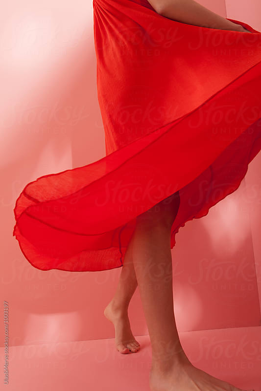young brunette with long red dress moving
