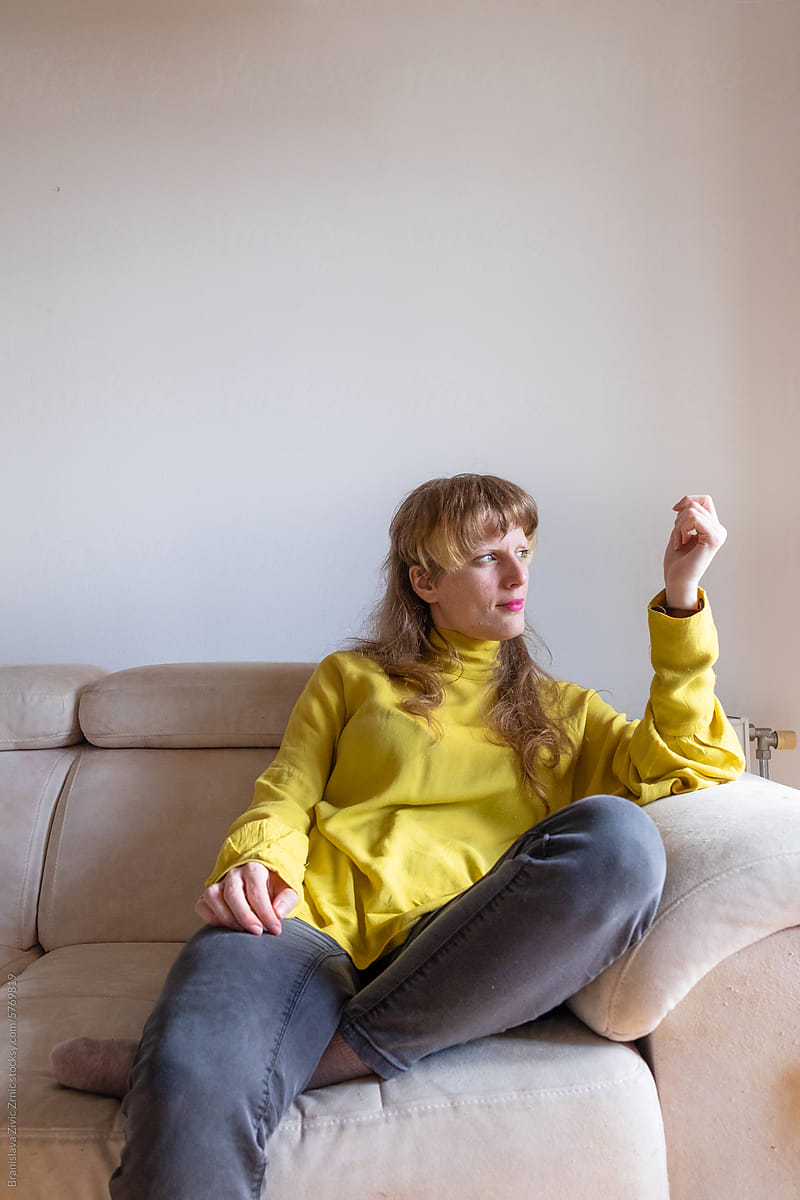 Portrait of a female sitting on the sofa at home