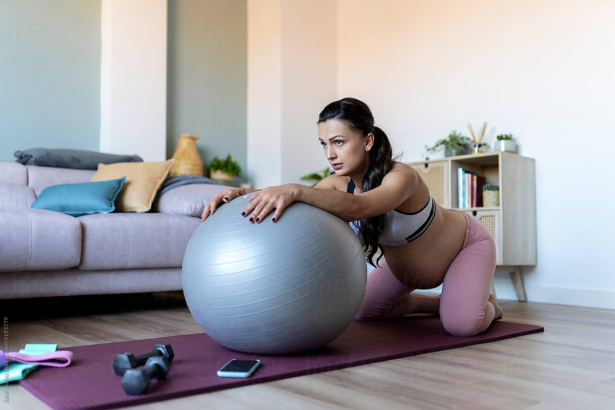 Pregnant Woman Stretching With A Pilates Ball