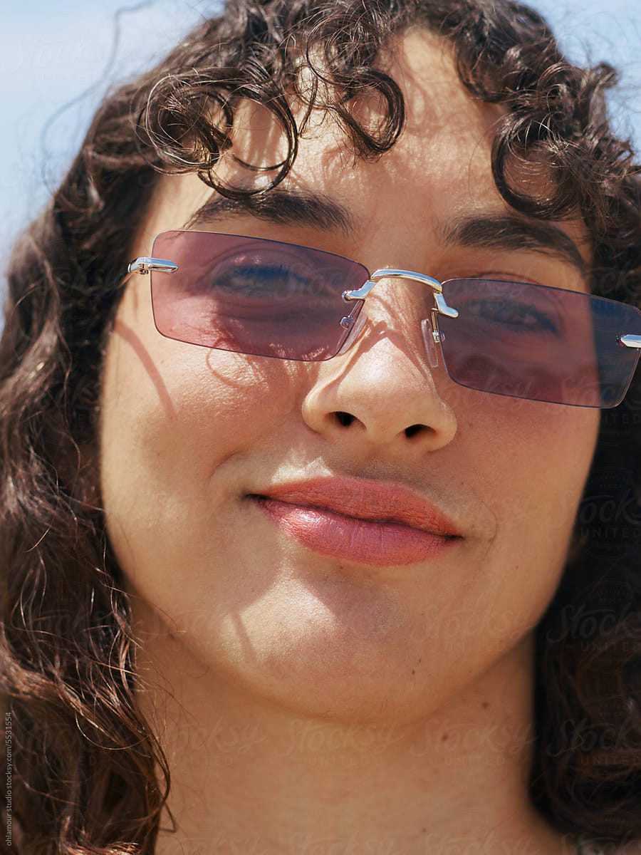 Close-up Portrait of Woman with Curly Hair on the Beach