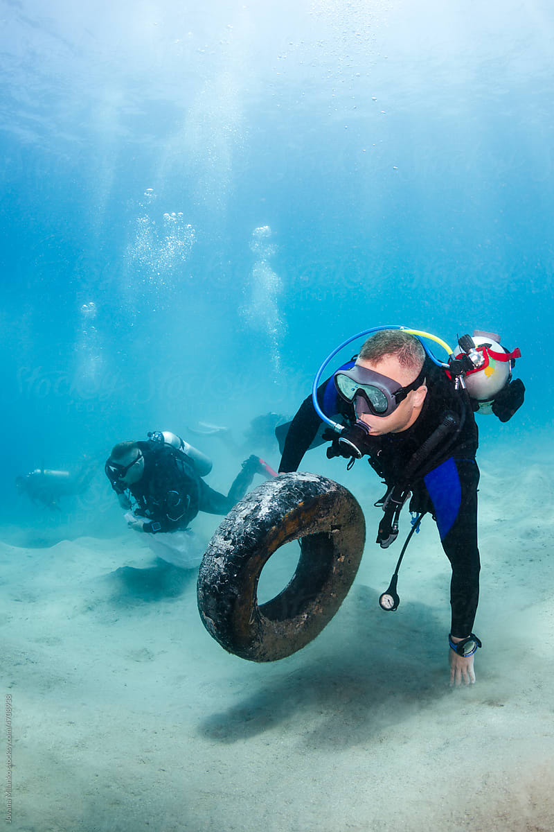 Man Cleaning Up the Ocean from Trash Tires