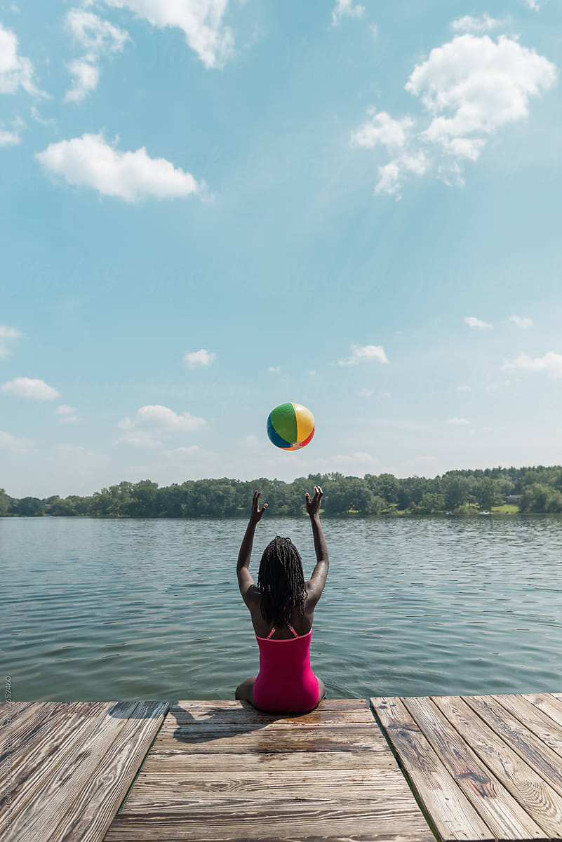 Black Girl Throwing A Beach Ball