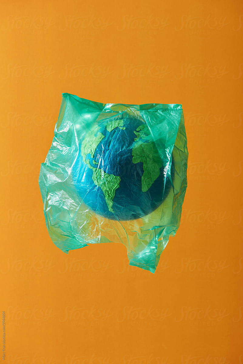 Globe wrapped in a plastic bag. Creative concept